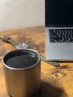 coffee cup on desk with laptop