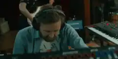 man playing keyboard in studio
