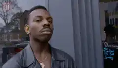 Man smirking and touching his ear