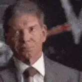Vince McMahon nodding and looking down