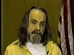 Charles Manson smirking and nodding