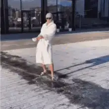 Woman in bathrobe dancing in snow