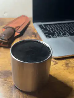 Steam rising from a metal cup of coffee