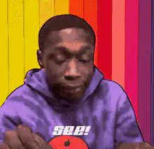 Man shrugging in purple hoodie