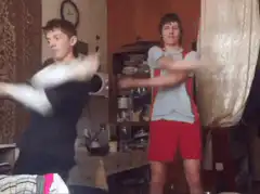 Two boys dancing in a living room