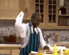 man in apron chopping food