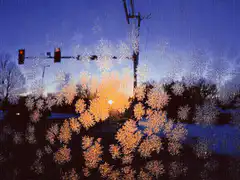 Snowflakes on window with sunset