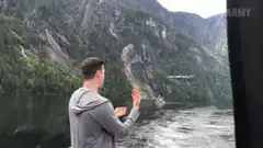 man catches drone on boat