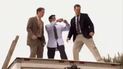Three men jump from truck to building