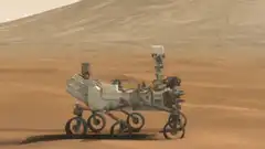 Mars rover driving on red sand