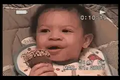 Baby eating cupcake and laughing