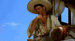 Man in sombrero rubbing face