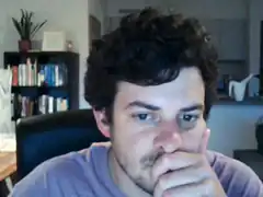 man with hand over mouth