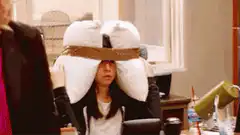 Penny with pillows on head