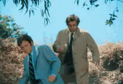 Two men running down a hill