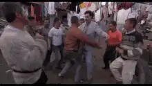 Men dancing in a crowded street