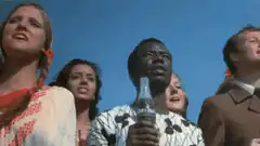 Diverse group singing with Coca-Cola bottles