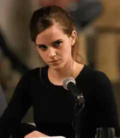 Emma Watson smirking at microphone