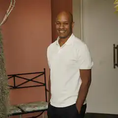 Ray Lewis smiling in white polo