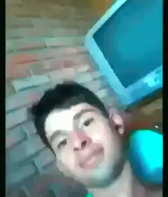 man smiling with blue monitor