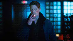 Man smoking cigarette in blue light