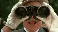 Man with binoculars sticking tongue out