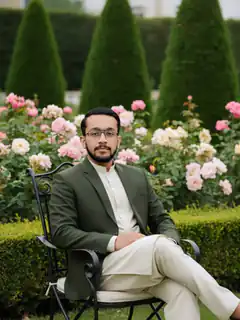 Man in green suit sitting in garden