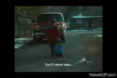 Boy walking away from truck with suitcase