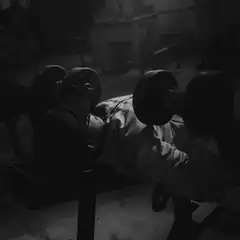 man lifting dumbbells on bench