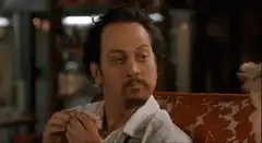 Rob Schneider eating with a satisfied look
