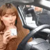 Woman drinking coffee in car