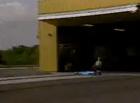 Man on skateboard hits a wall of bricks