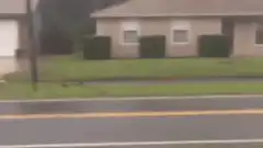 Boy running with American flag in rain
