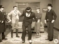 Man in suit dancing energetically