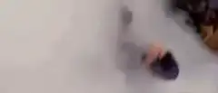 Man in purple jacket pumping fists