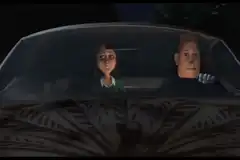 Woman in car points and kisses man