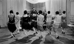 women dancing in 1920s flapper dresses