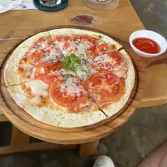 Tomato and cheese pizza on wooden board