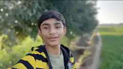 Boy in striped hoodie outdoors