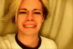 blonde woman crying and wincing
