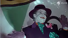 Joker falls backward laughing