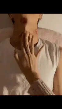Hand with rings touching neck with red marks