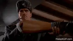 Arnold Schwarzenegger loads a shotgun