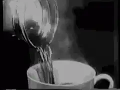 pouring hot tea into a cup
