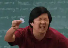 Ken Jeong squinting at a small piece of paper