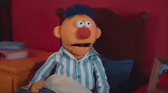 Bert sitting in bed looking confused
