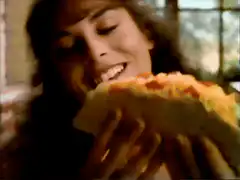 Woman eating pizza and wide-eyed