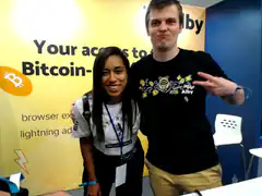 Couple posing at Bitcoin Alby booth