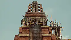 Ancient temple with figures and sunflowers
