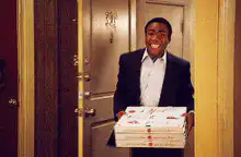 Troy Barnes brings pizza to the fire